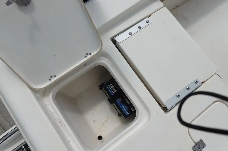 Slide: The Image of Storage compartment on a 2015 Key West 230 Bay Reef boat with battery inside. - 11