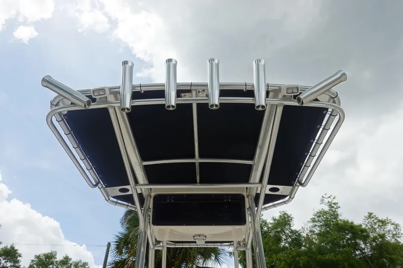 Slide: The Image of T-top of 2015 Key West 230 Bay Reef boat with rod holders against cloudy sky. - 13