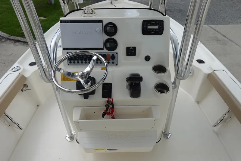 Slide: The Image of 2015 Key West 230 Bay Reef boat console with steering wheel and controls. - 15