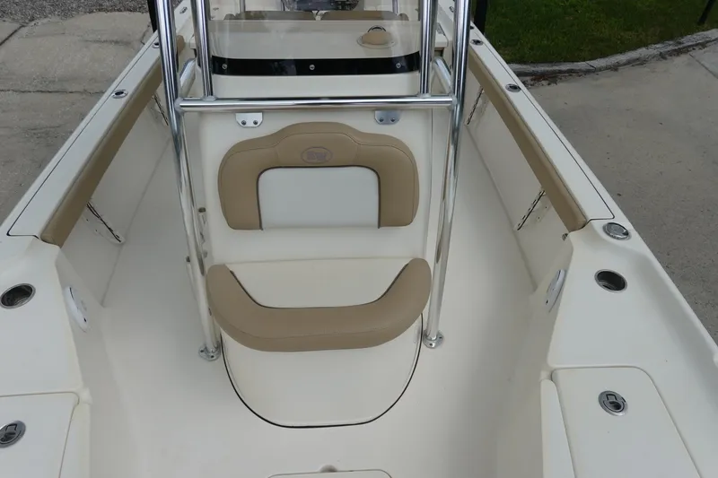 Slide: The Image of 2015 Key West 230 Bay Reef boat interior with beige seating and stainless steel railings. - 17