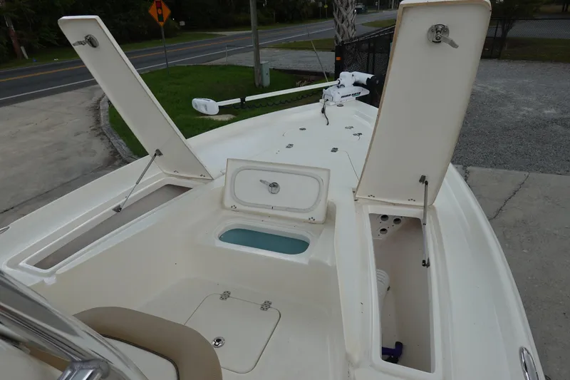 Slide: The Image of 2015 Key West 230 Bay Reef boat deck with open storage compartments and trolling motor. - 21