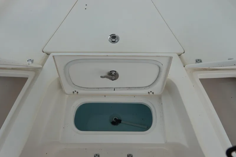Slide: The Image of 2015 Key West 230 Bay Reef boat storage compartments and livewell. - 23