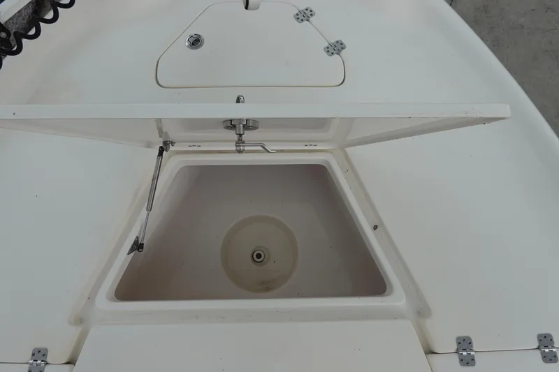 Slide: The Image of Open storage compartment on a 2015 Key West 230 Bay Reef boat. - 25