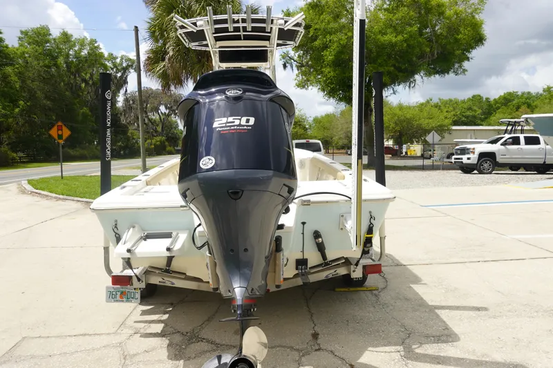 Slide: The Image of 2015 Key West 230 Bay Reef boat with powerful 250 horsepower engine, parked outdoors. - 6