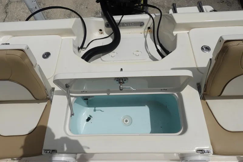 Slide: The Image of 2015 Key West 230 Bay Reef boat interior with open storage compartment. - 9