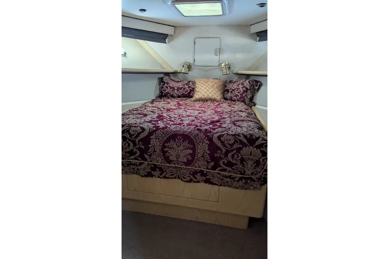 Slide: The Image of Luxurious bedroom interior of 1992 Viking 65 Motor Yacht with elegant bedding. - 12