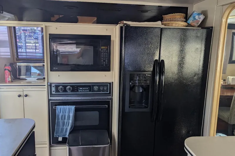 Slide: The Image of Kitchen area of a 1992 Viking 65 Motor Yacht with appliances and cabinetry. - 13