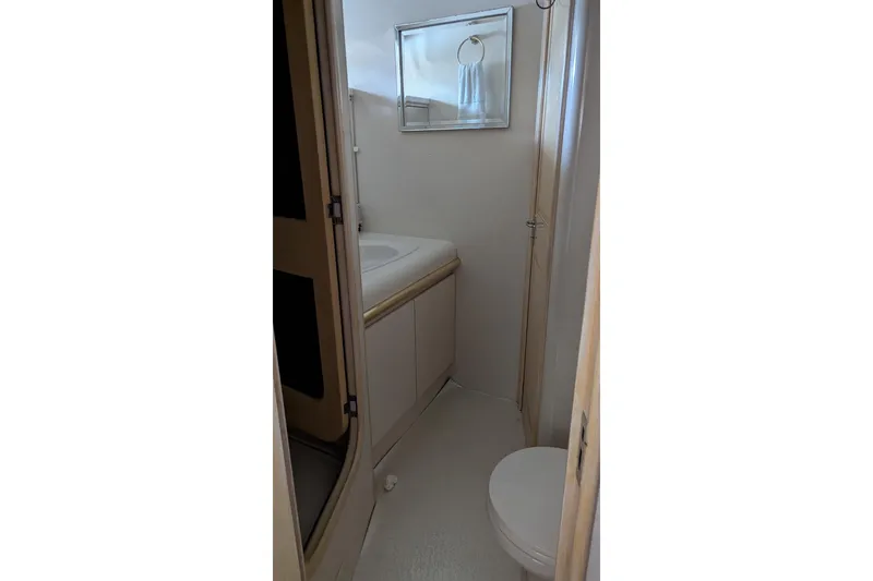 Slide: The Image of Bathroom interior of 1992 Viking 65 Motor Yacht, featuring sink and toilet. - 15