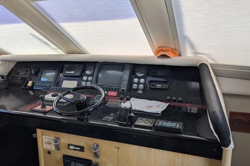 Slide: The Image of Cockpit of 1992 Viking 65 Motor Yacht with navigation instruments and steering wheel. - 16