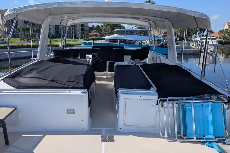 Slide: The Image of 1992 Viking 65 Motor Yacht with covered seating, docked in a marina. - 17