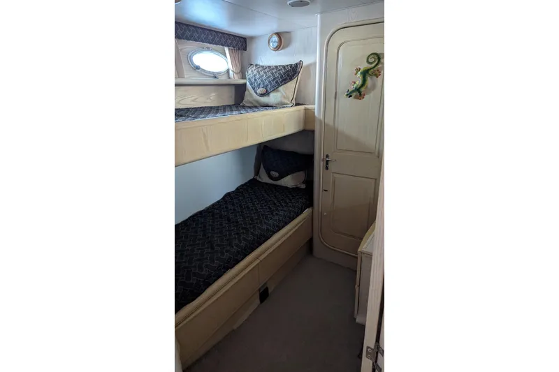 Slide: The Image of Cozy cabin with bunk beds in 1992 Viking 65 Motor Yacht. - 21