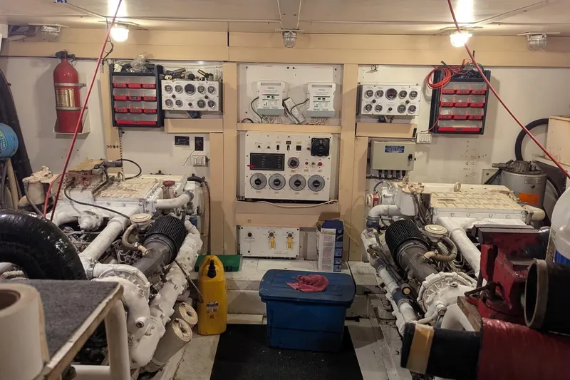 Slide: The Image of Engine room of a 1992 Viking 65 Motor Yacht with control panels and equipment. - 29