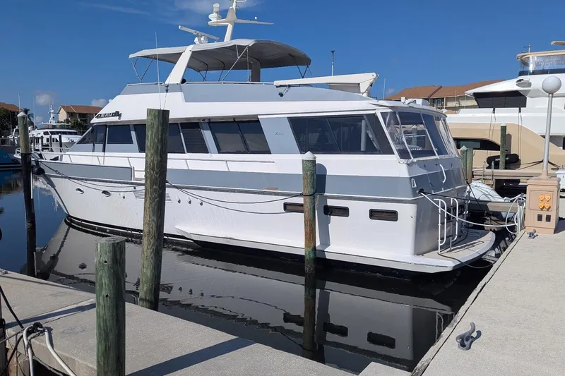 Slide: The Image of 1992 Viking 65 Motor Yacht docked at marina under clear blue sky. - 3
