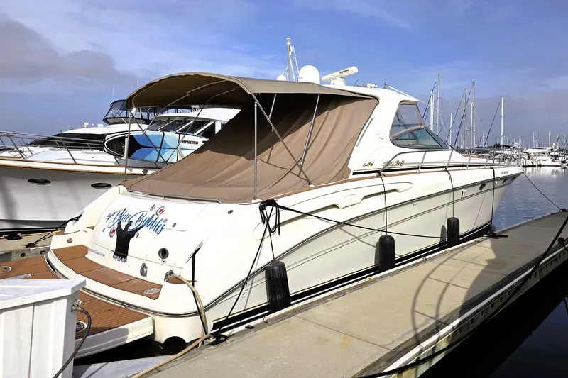The Image of 1999 Sea Ray Sundancer 540 yacht docked at marina under clear sky. - 0