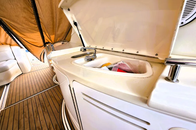 Slide: The Image of 1999 Sea Ray Sundancer 540 yacht interior with open sink and wooden deck. - 12