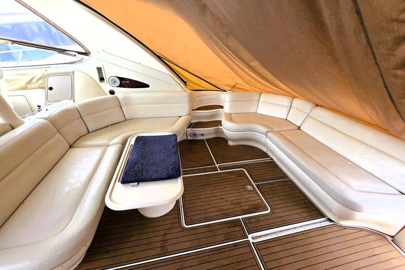 Slide: The Image of Luxurious interior of 1999 Sea Ray Sundancer 540 yacht with plush seating and wooden flooring. - 13