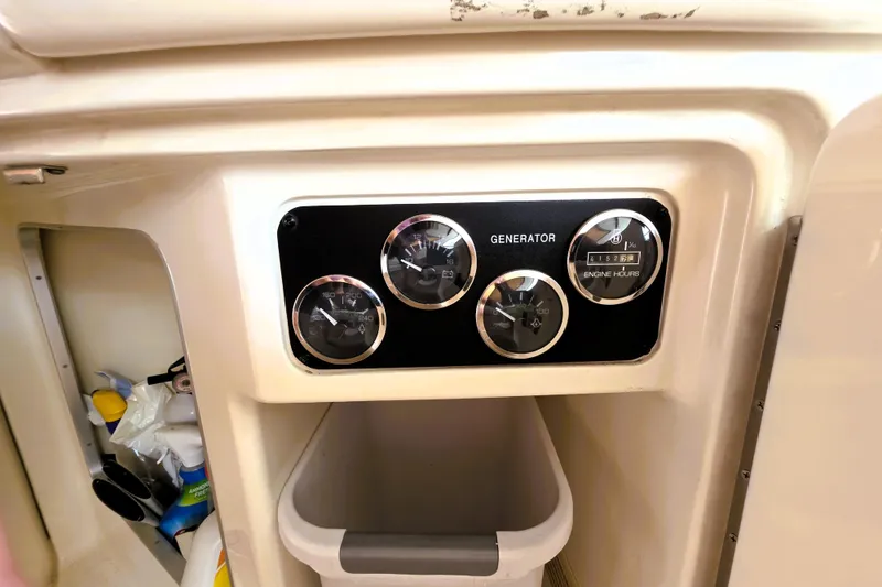 Slide: The Image of Control panel of a 1999 Sea Ray Sundancer 540 boat, showing generator gauges. - 14