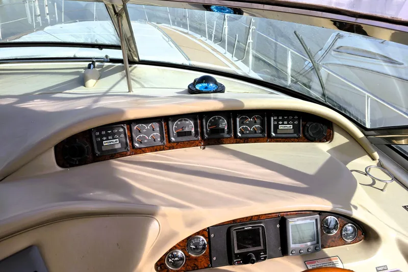 Slide: The Image of 1999 Sea Ray Sundancer 540 dashboard with gauges and navigation equipment. - 23