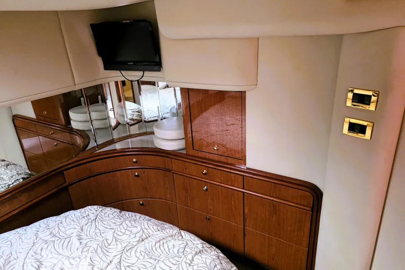 Slide: The Image of Luxurious cabin interior of 1999 Sea Ray Sundancer 540 yacht with wood cabinetry and TV. - 26