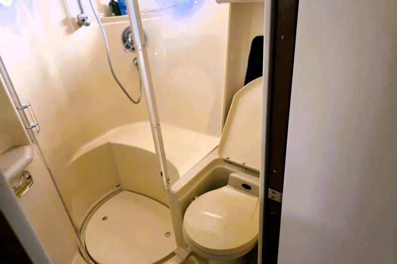 Slide: The Image of Bathroom interior of 1999 Sea Ray Sundancer 540 yacht, featuring shower and toilet. - 28