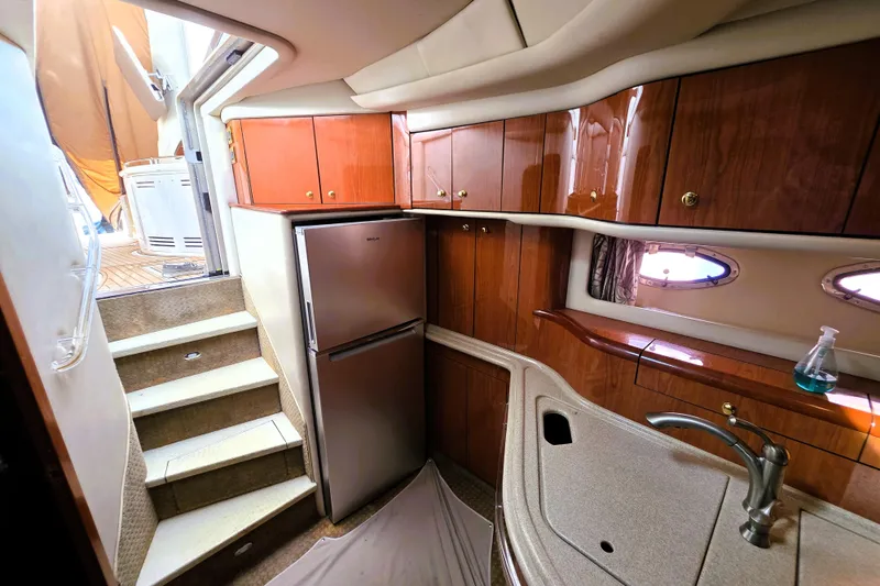 Slide: The Image of Interior of 1999 Sea Ray Sundancer 540 yacht with kitchenette and stairs to deck. - 3