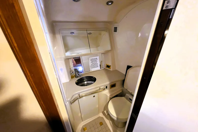 Slide: The Image of Bathroom interior of 1999 Sea Ray Sundancer 540 yacht, featuring sink and toilet. - 8