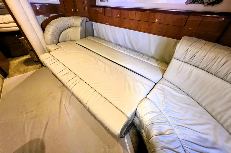 Slide: The Image of Luxurious interior seating of 1999 Sea Ray Sundancer 540 yacht, featuring plush cream upholstery. - 9