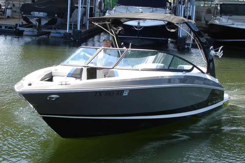 Slide: The Image of 2017 Regal 2300 RX Surf boat on water, featuring sleek design and modern features. - 14