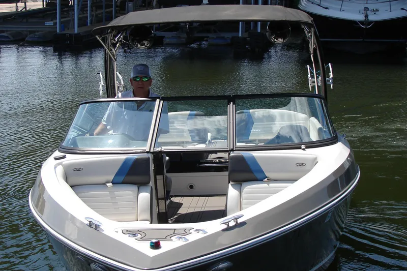 Slide: The Image of 2017 Regal 2300 RX Surf boat on water, featuring sleek design and spacious seating. - 15