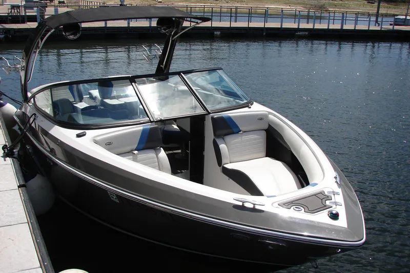 Slide: The Image of 2017 Regal 2300 RX Surf boat docked on calm water. - 16