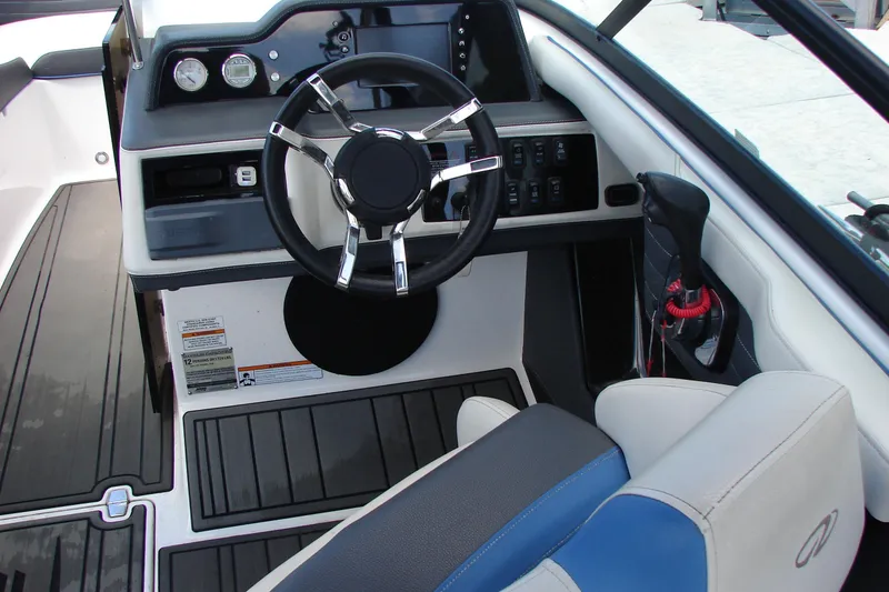 Slide: The Image of 2017 Regal 2300 RX Surf boat cockpit with steering wheel and controls. - 22