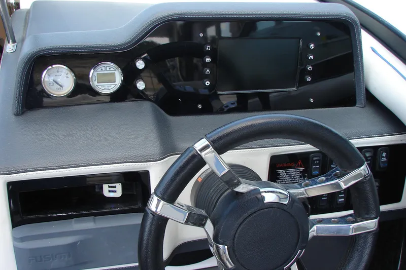 Slide: The Image of Dashboard of a 2017 Regal 2300 RX Surf boat with steering wheel and controls. - 25