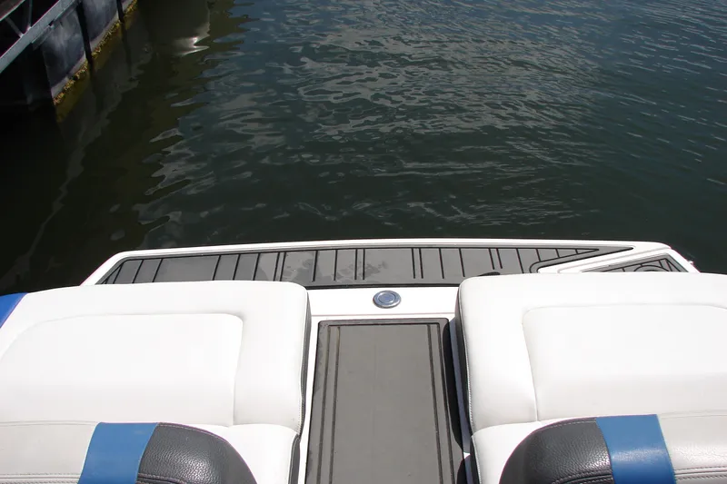 Slide: The Image of 2017 Regal 2300 RX Surf boat interior with white seating and water view. - 28