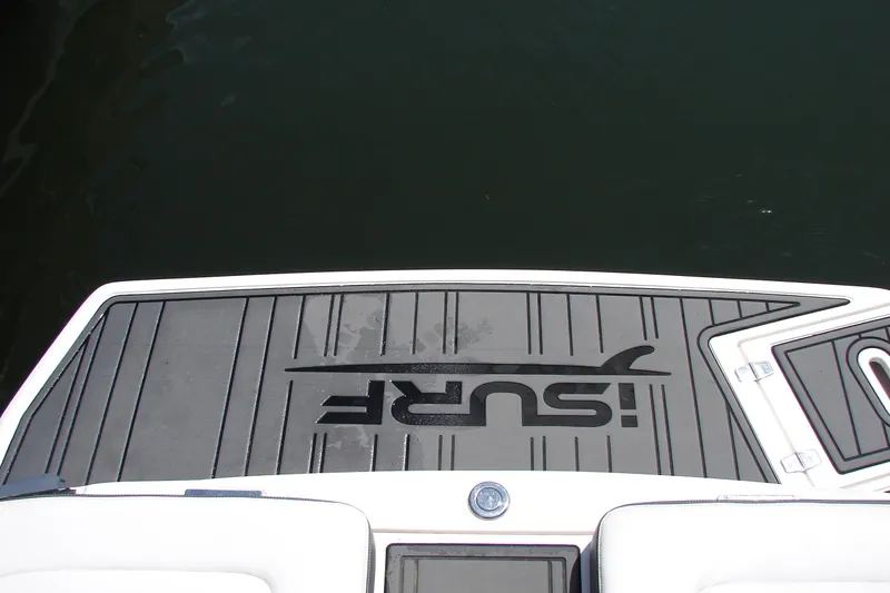 Slide: The Image of 2017 Regal 2300 RX Surf boat swim platform with "Surf" logo, on calm water. - 29