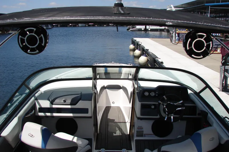 Slide: The Image of 2017 Regal 2300 RX Surf boat interior at dock, featuring sleek design and modern controls. - 30