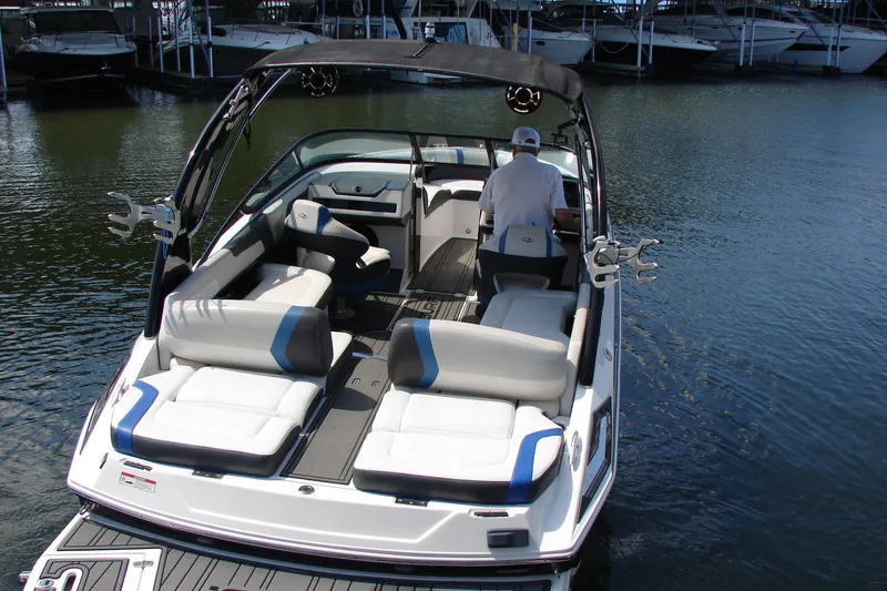 Slide: The Image of 2017 Regal 2300 RX Surf boat with spacious seating on calm water. - 4