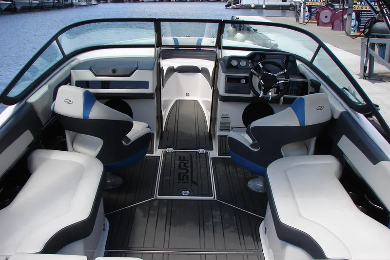 Slide: The Image of Interior of a 2017 Regal 2300 RX Surf boat with seating and steering wheel. - 5