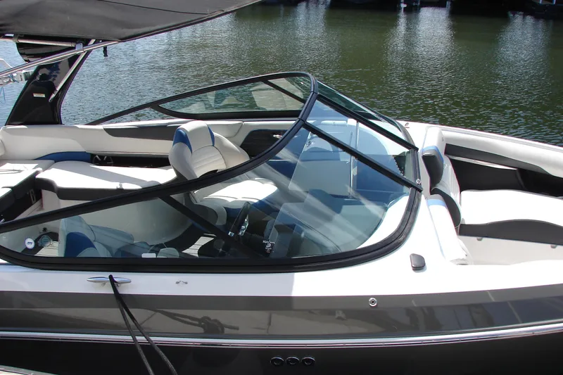 Slide: The Image of 2017 Regal 2300 RX Surf boat with sleek interior design on calm water. - 8