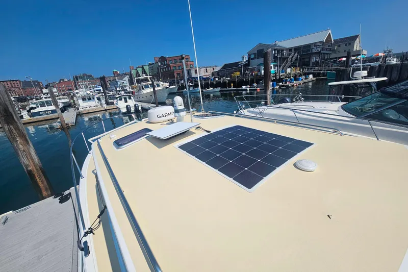 Slide: The Image of 2023 MJM 35 boat with solar panel docked at a marina. - 17
