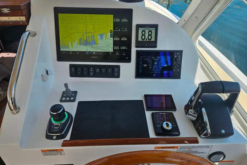 Slide: The Image of Control panel of 2023 MJM 35 boat with navigation and throttle systems. - 35