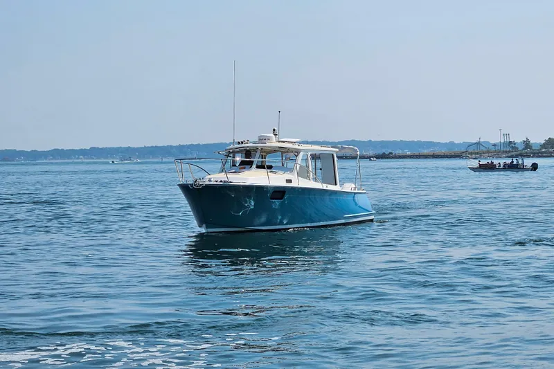 Slide: The Image of 2023 MJM 35 boat cruising on calm blue waters under a clear sky. - 5