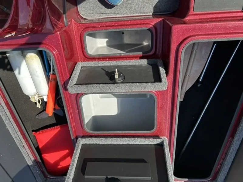 Slide: The Image of Interior view of a 2011 Triton 17 Explorer boat with storage compartments. - 11