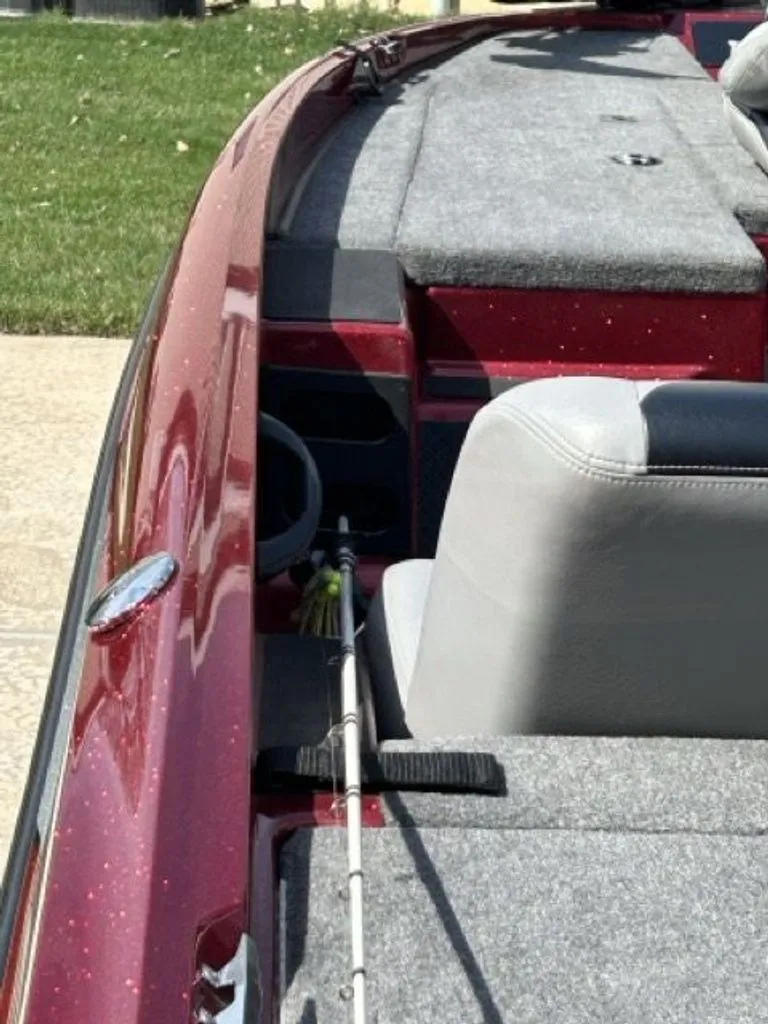 Slide: The Image of Red Triton 17 Explorer 2011 with gray seats and fishing rod. - 12