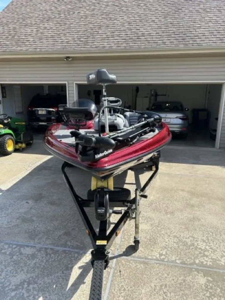 Slide: The Image of 2011 Triton 17 Explorer boat on trailer in front of garage. - 15