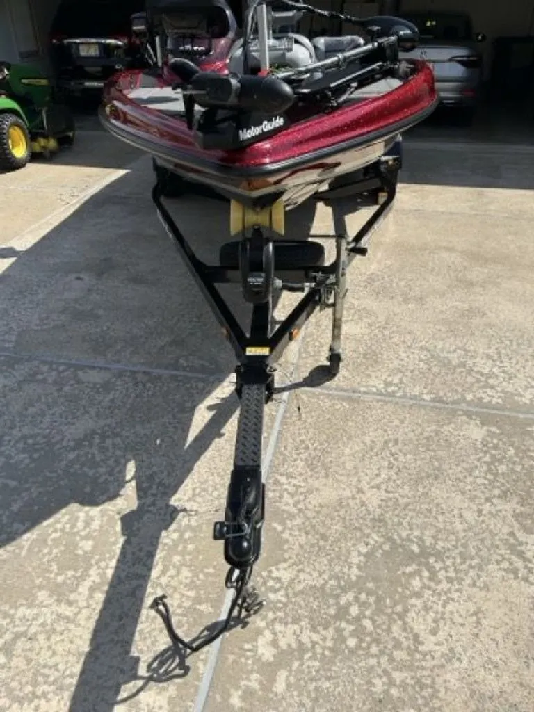 Slide: The Image of 2011 Triton 17 Explorer boat on trailer in driveway. - 17