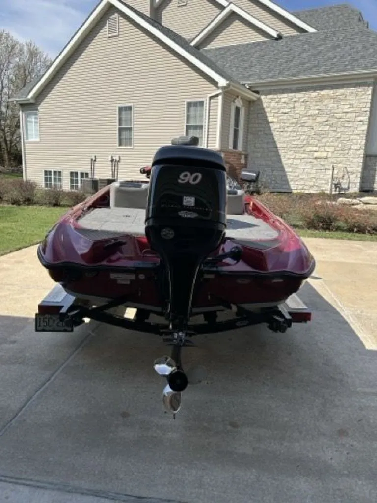 Slide: The Image of Red 2011 Triton 17 Explorer boat parked in driveway. - 18