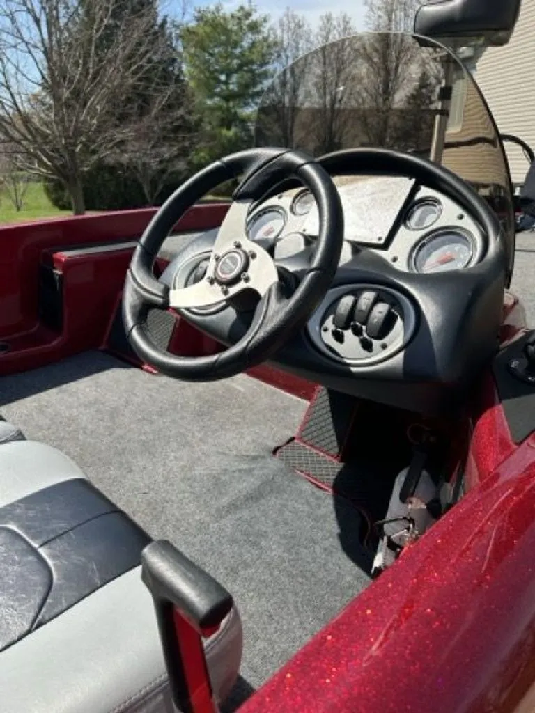 Slide: The Image of Interior view of a 2011 Triton 17 Explorer boat with steering console. - 4
