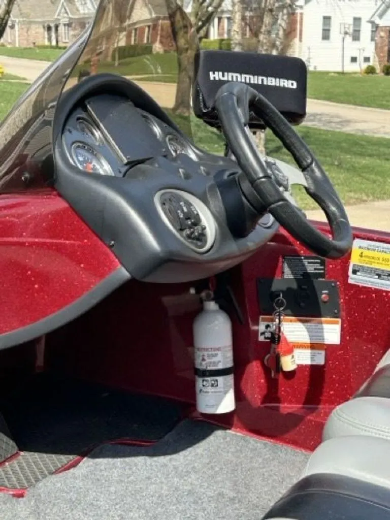 Slide: The Image of Interior of a 2011 Triton 17 Explorer boat with steering wheel and instruments. - 5