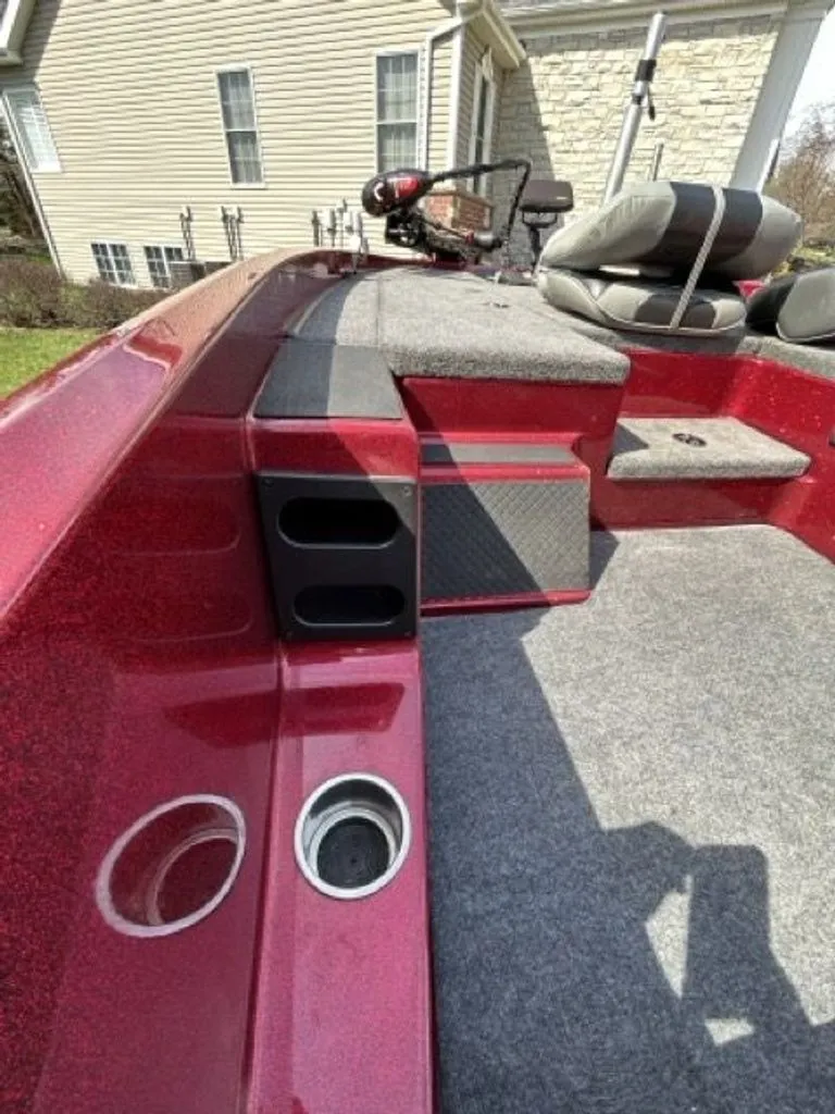 Slide: The Image of Interior of a 2011 Triton 17 Explorer boat with red accents. - 6