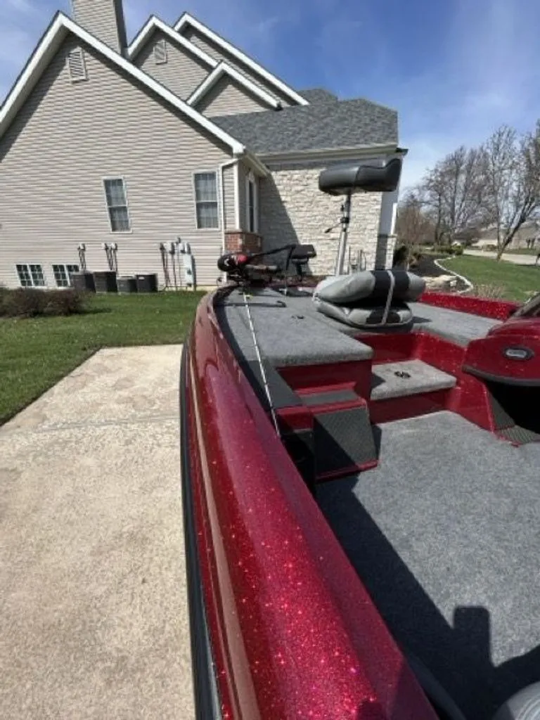 Slide: The Image of Red Triton 17 Explorer 2011 boat parked in front of a house. - 7
